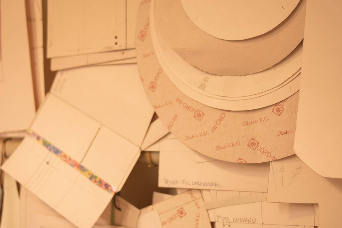 Close-up of biodegradable paper products for food service being used in a busy café with steam rising from coffee cups